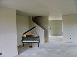 The living room from the other end showing where the piano will go.